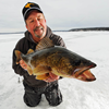 image of Tom Neustrom ice fishing for Walleye